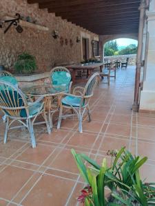 a patio with a table and chairs on a tile floor at Son Pujol in Las Ollerías