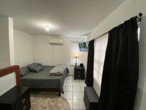 a small bedroom with a bed and a window at Casa empresarial 5 minutos de puente internacional in Reynosa