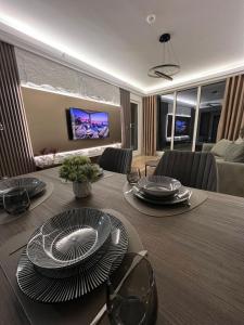 a dining room with a table with plates on it at Stellarlux Apartment, 35th floor in Skopje
