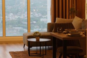 a living room with a couch and a table at Stellarlux Apartment, 35th floor in Skopje