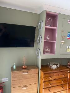 a room with a flat screen tv on a wall at Private en-suite RUTHIN in Llanfair-Dyffryn-Clwyd