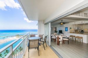 a balcony with a view of the beach at Ilikai Tower 1744 Yacht Harbor View 2BR in Honolulu