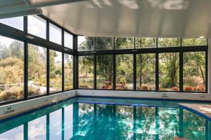a large swimming pool with a large window at Balgownie Estate Yarra Valley in Yarra Glen