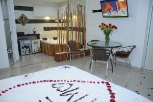 a room with a table and a dining room at Hotel villeta suite in Villeta