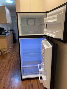 an empty refrigerator with its door open in a kitchen at Oasis Resort with heated pool & hottub in Oceanside