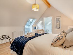 a bedroom with a large bed in a attic at 4 Bed in Newmachar 93914 in Dyce