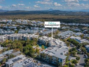 an overhead view of a city with a sign that reads therapy management at Drift North Beachfront Apartments - Private Apartments in Kingscliff