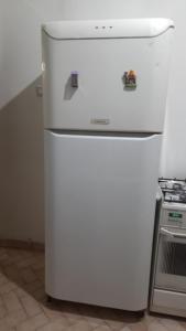 a white refrigerator in a kitchen next to a stove at Şirinevler Guest house in Istanbul