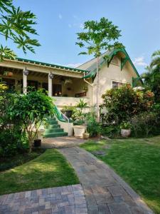 a house with a slide in front of it at The Puakenikeni Suite at the Historic Wailuku Inn in Wailuku