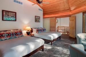 a bedroom with two beds and a ceiling fan at Boardman Monarch! River! Hot Tub! Fireplace! in Traverse City