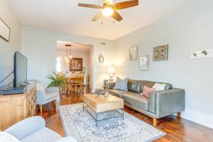 a living room with a couch and a tv at Furnished Patio and Yard Denver Bungalow! in Denver