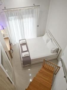 een kleine slaapkamer met een bed en een stoel bij Alexiou Luxury Villa in Aigio