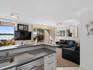 a kitchen and living room with a couch at Yarrawonga Lakeside Apartment 25 in Mulwala