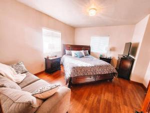 a bedroom with a bed and a couch at Pet Friendly Mtn Cabin on 40 Acres 2 King Beds in Leadville
