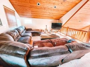 ein Wohnzimmer mit einem großen Sofa in einem Haus in der Unterkunft Pet Friendly Mtn Cabin on 40 Acres 2 King Beds in Leadville