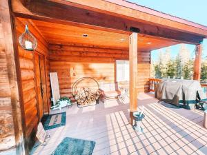 a porch of a log cabin with a table and chairs at Pet Friendly Mtn Cabin on 40 Acres 2 King Beds in Leadville