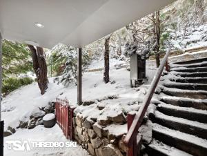 a snow covered stairway with snow on it at Chamonix in Thredbo