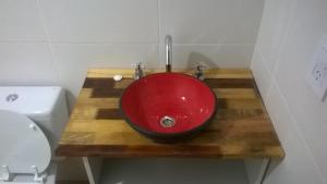 baño con lavabo rojo en una encimera de madera en MADRESELVA en San Rafael