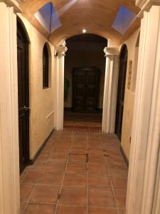 an empty hallway of a house with a tile floor at Casa Familiar San Sebastian in Antigua Guatemala
