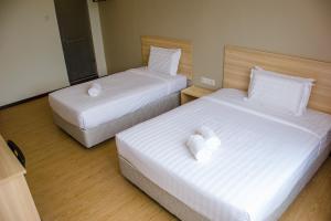 Postel nebo postele na pokoji v ubytování 1 Orange Hotel Sungai Buloh