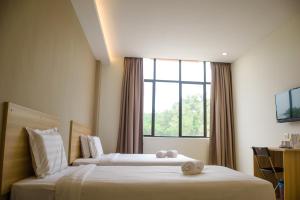 Postel nebo postele na pokoji v ubytování 1 Orange Hotel Sungai Buloh
