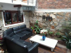 a couch and a coffee table on a patio at Ríos Voladores Hostel in Bogotá