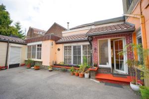 a house with potted plants in front of it at Village Fertile in Charleroi