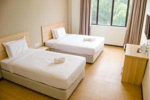 Postel nebo postele na pokoji v ubytování 1 Orange Hotel Sungai Buloh