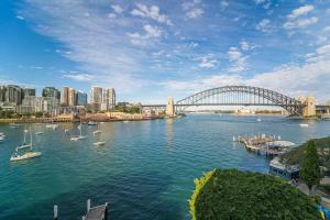 a view of a river with a bridge and boats at Harbourside #32 in Sydney
