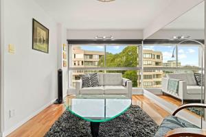 a living room with a couch and a glass table at Heart Of The City Minutes from Macleay Street in Sydney