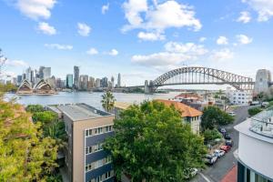 a view of the sydney harbour bridge and opera house at Lovely Apartment with Spectacular Views in Sydney