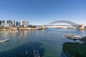 a view of a river with a bridge and boats at Harbourside #31 in Sydney