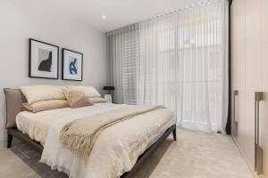 a bedroom with a bed and a large window at Terrace Boutique in the Heart of The Rocks in Sydney
