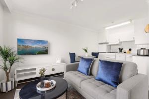 a living room with a couch and a table at Harbourside #15 in Sydney