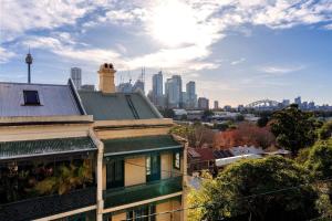 a view of the sydney city skyline from a building at Top Floor Apartment with Harbour Views in Sydney