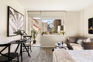 a living room with a couch and a table at Sunny Spot Potts Point in Sydney