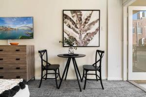 a dining room with a table and two chairs at Sunny Spot Potts Point in Sydney