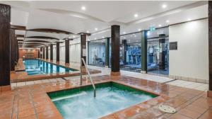 a pool in the middle of a building at 1 BR Apartment In the Heart of Darling Harbour in Sydney