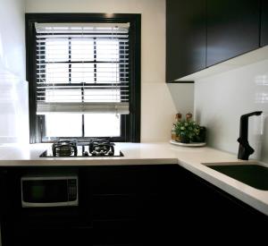 a kitchen with a window and a sink and a stove at Lux & Quiet Apartment in, Potts Point in Sydney