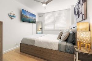 1 dormitorio con cama y ventana en Stylish Manly Apartment with Harbour Views en Sídney