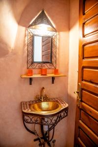 a bathroom with a sink and a mirror at Riad The Moroccans Pool And Terrace in Marrakech