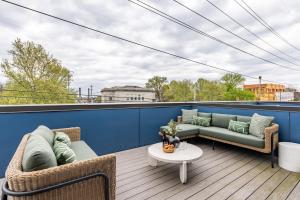 a patio with two couches and a table on a roof at Outrider 103 by AvantStay 2miles to DT Nash in Nashville