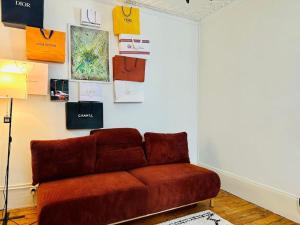 a living room with a brown couch in a room at Studio animé et nifty à Paris/Denfert Rochereau in Paris