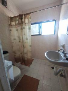 łazienka z umywalką, toaletą i oknem w obiekcie Cerca de laguna y embarcadero hacia isla lobos w mieście Tamiahua