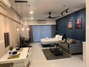 a living room with a bed and a couch at Summer Suites KLCCby Victoria in Kuala Lumpur