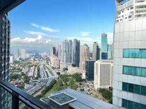 a view of the city from the balcony of a building at Summer Suites KLCCby Victoria in Kuala Lumpur