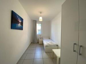a small bedroom with a bed and a window at 4 bedroom apartment with pool & jacuzzi in Maccagno Inferiore