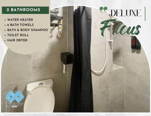 a magazine advertisement for a bathroom with a toilet and shower at Roxy Sematan Beach Townhouse Deluxe , 1 & 2 in Sematan