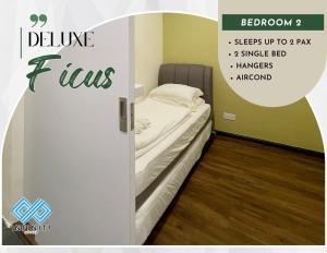 ein kleines Bett in einem kleinen Zimmer mit einer Tür in der Unterkunft Roxy Sematan Beach Townhouse Deluxe , 1 & 2 in Sematan