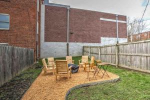 a patio with chairs and a table and a fence at Beautiful Boho Villa on Vine in the heart of Lancaster in Lancaster